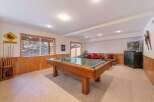 Enjoy endless entertainment in this finished basement, featuring a full-size pool table perfect for game nights.