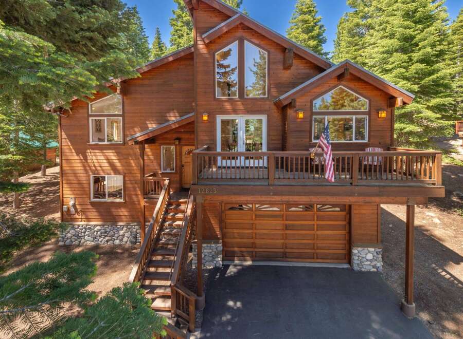 Experience mountain living in this stunning wooden home, nestled among tall pine trees.