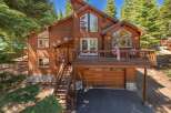 Experience mountain living in this stunning wooden home, nestled among tall pine trees.
