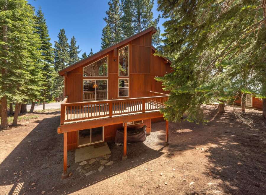 Experience mountain living in this charming wooden cabin, nestled amongst tall pine trees.