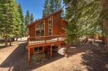 Experience mountain living in this charming wooden cabin, nestled amongst tall pine trees.
