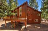 Experience mountain living in this stunning wood-sided home, featuring a spacious wrap-around deck perfect for outdoor entertaining and enjoying the serene forest surroundings.