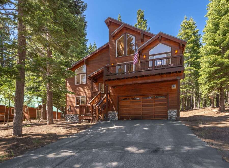 Experience mountain living in this stunning wooden home nestled amongst tall pine trees.
