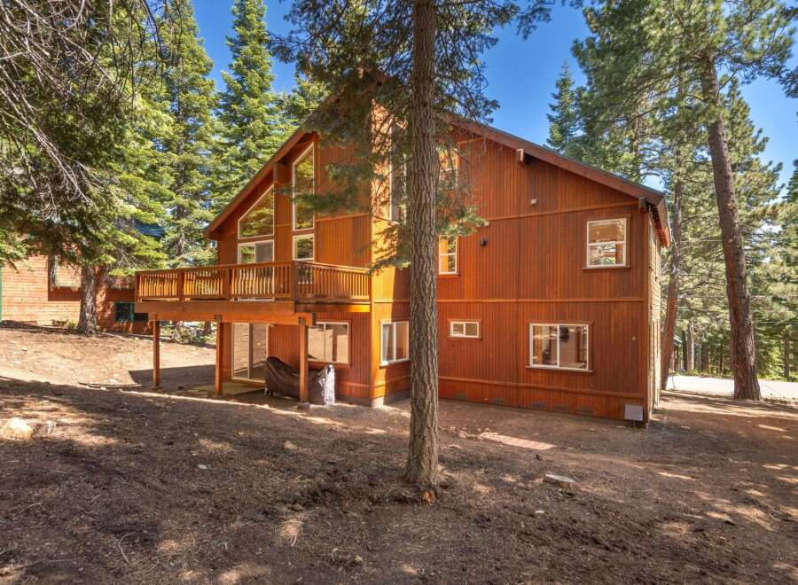 Nestled amidst tall pine trees, this charming wooden home offers a serene mountain retreat.