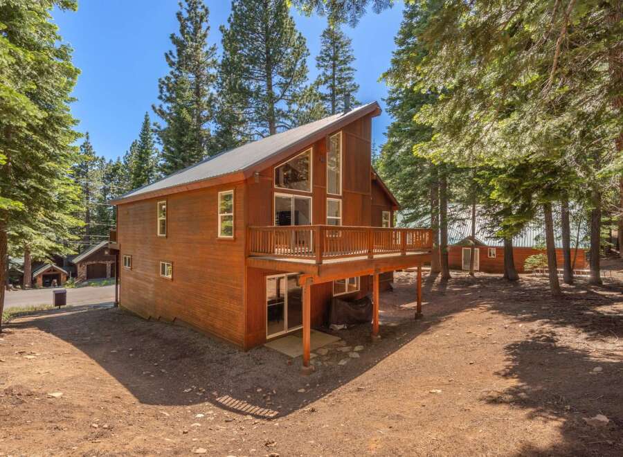 Nestled amidst tall pine trees, this charming wooden cabin offers a serene mountain retreat.