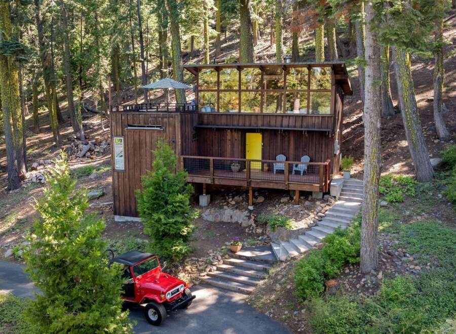 Nestled in a serene forest setting, this unique cabin offers a rustic retreat with modern touches.