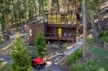 Nestled in a serene forest setting, this unique cabin offers a rustic retreat with modern touches.