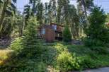 Nestled amidst towering trees, this unique wooden home offers a secluded mountain retreat.