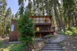 Nestled amongst towering trees, this unique wooden cabin offers a serene retreat with stunning natural views.
