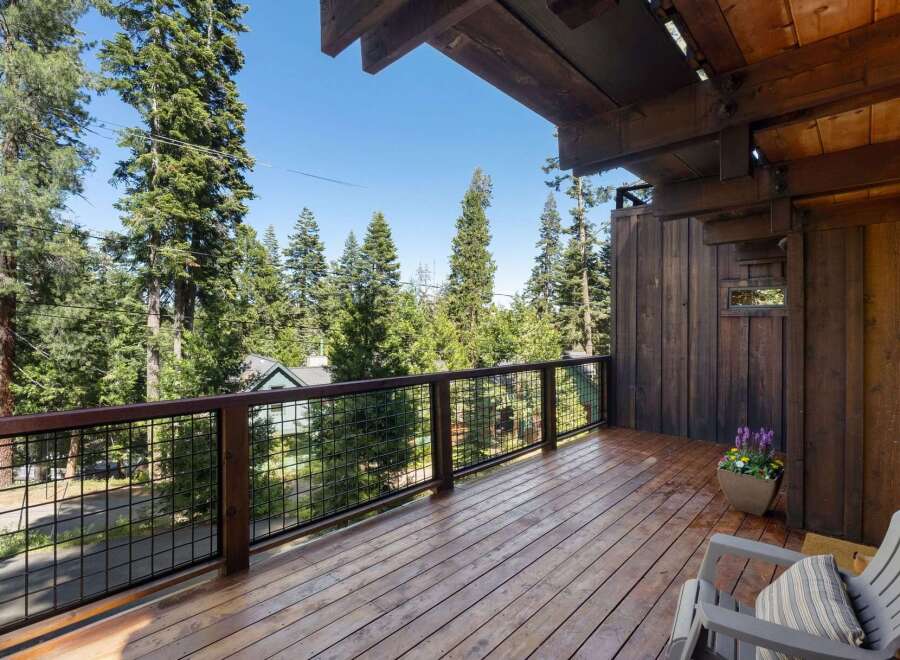Enjoy breathtaking forest views from this expansive wooden deck, perfect for outdoor living and entertaining.