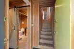 Discover unique charm in this home featuring a rustic barn door leading to a modern bathroom with a toilet and sink.