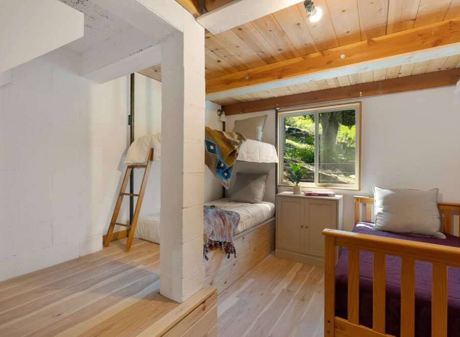 This charming room features a cozy bunk bed setup, perfect for accommodating guests or family.