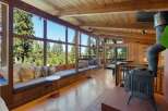 Experience breathtaking forest views from this stunning living space, featuring a wall of windows that floods the room with natural light.