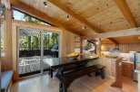 Experience rustic charm in this mountain retreat, featuring a spacious dining area with a wooden picnic table and benches, perfect for gathering.