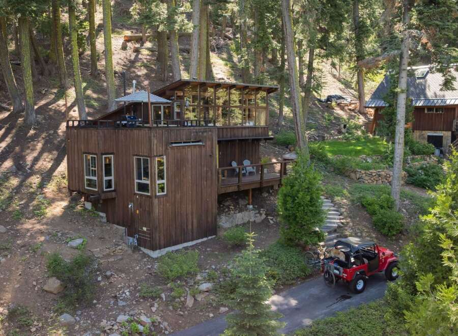 Nestled amidst towering trees, this unique wooden home offers a serene mountain retreat.