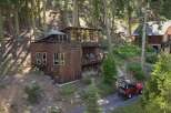 Nestled amidst towering trees, this unique wooden home offers a serene mountain retreat.