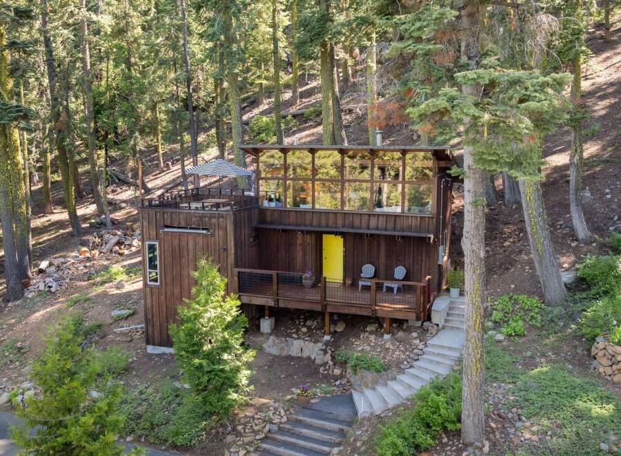 Nestled amidst a serene forest, this unique wooden cabin offers a tranquil retreat.