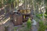 Nestled amidst a serene forest, this unique multi-level home offers a blend of modern design and natural charm.