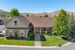 Discover this stunning single-family home featuring a beautifully manicured lawn and a welcoming front porch.