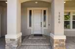 Welcome to this charming home featuring a beautiful arched entryway with decorative sidelights framing the elegant front door.