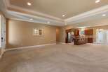 This spacious open-concept living area seamlessly connects to a modern kitchen, perfect for entertaining.