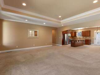 This spacious open-concept living area seamlessly connects to a modern kitchen, perfect for entertaining.
