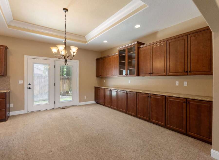 This spacious room features abundant custom cabinetry, offering ample storage and display space.