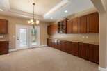 This spacious room features abundant custom cabinetry, offering ample storage and display space.