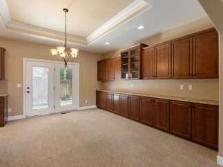 This spacious room features abundant custom cabinetry, offering ample storage and display space.