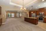 Experience open-concept living in this spacious home, featuring a large kitchen island perfect for entertaining and a bright, airy living area with a cozy fireplace.
