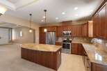 This spacious kitchen boasts rich cherry wood cabinetry and elegant granite countertops, perfect for the home chef.