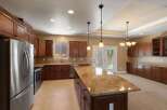 Experience culinary excellence in this spacious kitchen, featuring rich cherry wood cabinetry and elegant granite countertops.