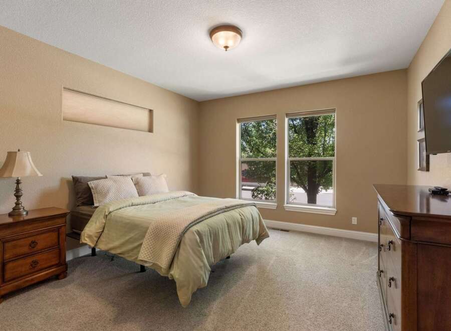 This inviting bedroom features a comfortable queen-size bed with plush bedding, perfect for a restful night's sleep.