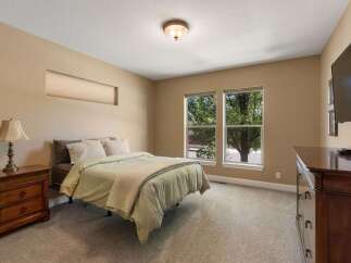 This inviting bedroom features a comfortable queen-size bed with plush bedding, perfect for a restful night's sleep.