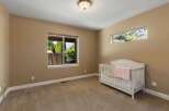 This charming nursery features a cozy crib adorned with a soft pink blanket, perfect for a little one.