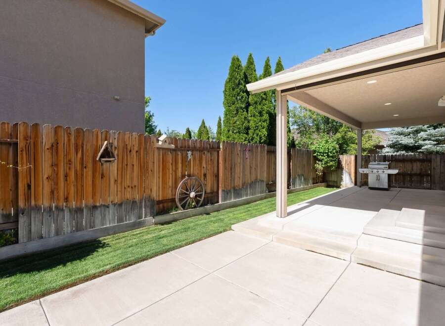 Enjoy outdoor living in this spacious backyard featuring a covered patio perfect for entertaining.