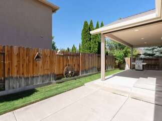Enjoy outdoor living in this spacious backyard featuring a covered patio perfect for entertaining.