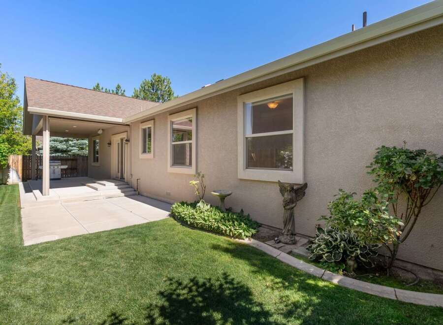 Enjoy outdoor living with this covered patio featuring a built-in grill, perfect for entertaining.
