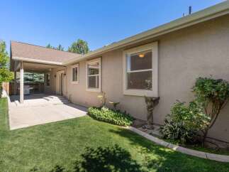 Enjoy outdoor living with this covered patio featuring a built-in grill, perfect for entertaining.