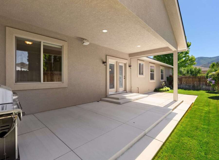 Enjoy outdoor living with this spacious covered patio, perfect for entertaining or relaxing.