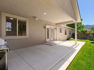 Enjoy outdoor living with this spacious covered patio, perfect for entertaining or relaxing.