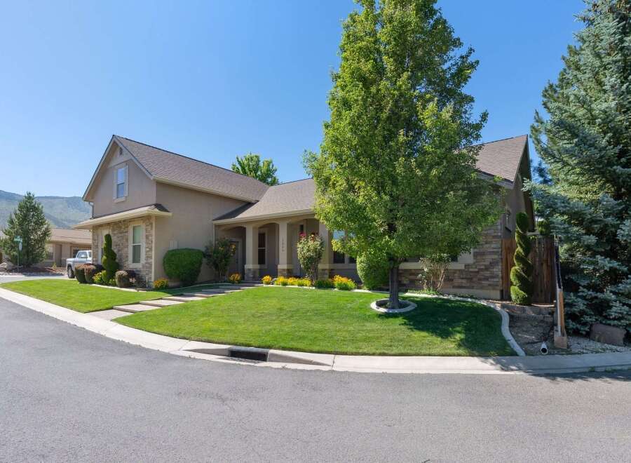 Discover this charming home featuring a beautifully manicured lawn and mature trees, perfect for outdoor enjoyment.