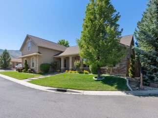 Discover this charming home featuring a beautifully manicured lawn and mature trees, perfect for outdoor enjoyment.