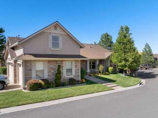 Discover this charming home featuring a beautiful stone facade and a well-maintained lawn.