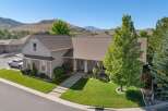 Discover this stunning home featuring a beautifully manicured lawn and a welcoming front porch with stately columns.
