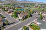 Discover this stunning aerial view of a suburban neighborhood, showcasing beautiful homes with well-maintained lawns and mature trees.
