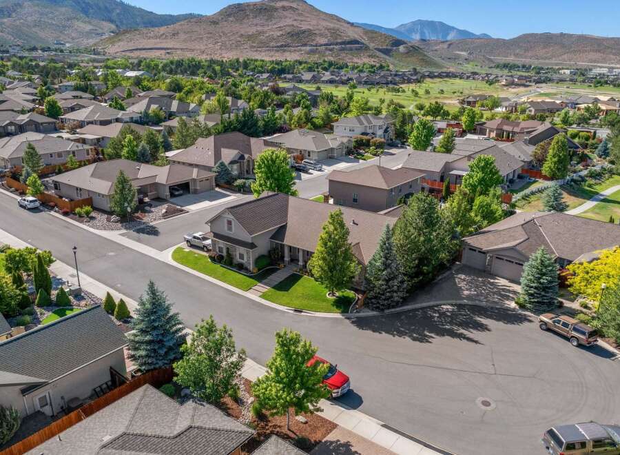 Discover this stunning suburban home nestled against a backdrop of rolling hills and a golf course.
