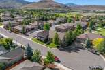 Discover this stunning suburban home nestled against a backdrop of rolling hills and a golf course.