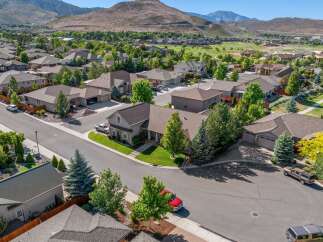 Discover this stunning suburban home nestled against a backdrop of rolling hills and a golf course.