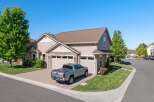 Discover this stunning home featuring a modern silver pickup truck parked in the driveway.